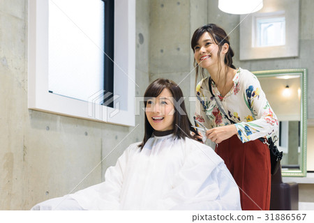 Young female hairdresser and female customer 31886567