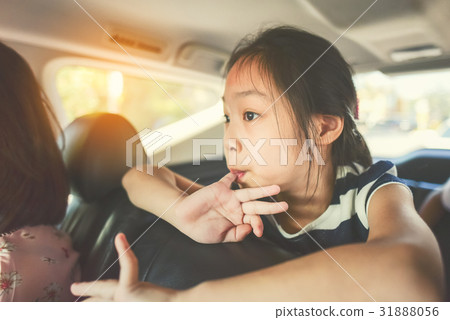 Asian girl sitting in car while travel with family 31888056