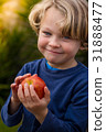 cute 5 year old child holding an apple 31888477