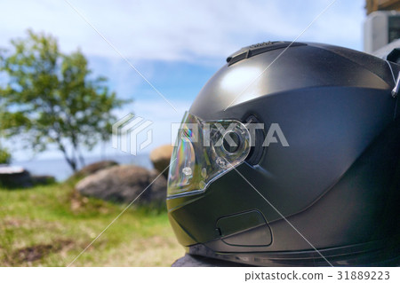 Helm of a motorcyclist on the beach Helm of a motorcyclist on the beach 31889223