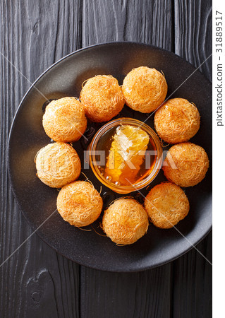 Turkish dessert kataifi with honey close-up 31889517