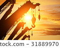 silhouette crane truck in flare light for logistic 31889970