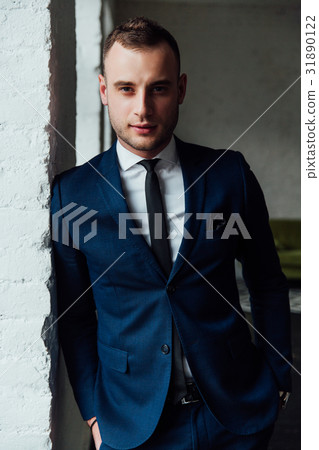 Young attractive and confident businessman in blue Young attractive and confident businessman in blue 31890122