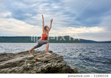 Young woman standing on the stone and practicing 31890338