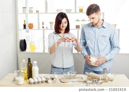happy Couple in love cooking dough in kitchen happy Couple in love cooking dough in kitchen 31891919
