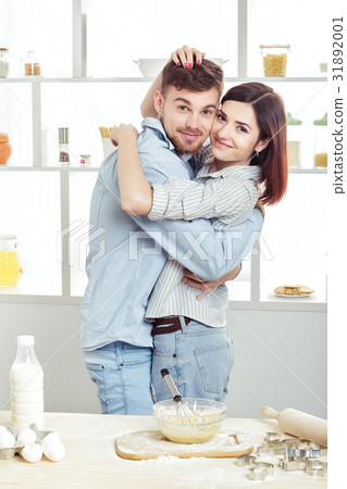 happy Couple in love cooking dough in kitchen happy Couple in love cooking dough in kitchen 31892001