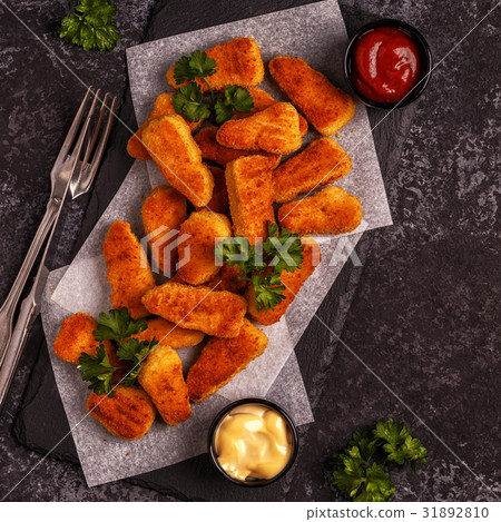 Chicken nuggets with sauces on dark background. Chicken nuggets with sauces on dark background. 31892810