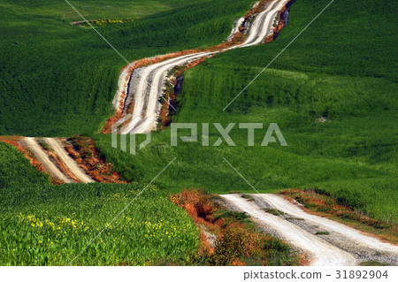A long and winding rural path crosses the hills A long and winding rural path crosses the hills 31892904