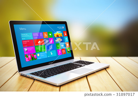 Laptop on wooden table outdoors 31897017