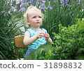 Little girl in the garden. 31898832