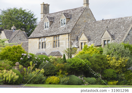 old stone houses with flowering gardens in village 31901296