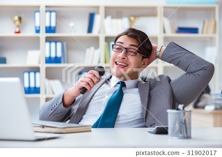 Businessman singing in the office 31902017