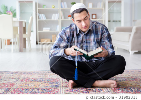 Muslim man praying at home Muslim man praying at home 31902313
