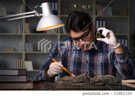 Archeologist working late night in office Archeologist working late night in office 31902320