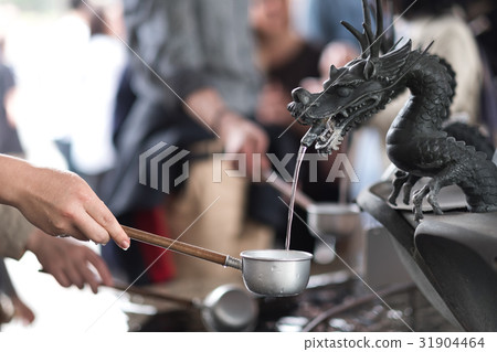 Metal dragon spewing water in the well  31904464