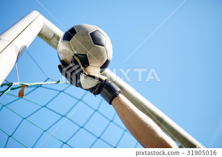 goalkeeper with ball at football goal over sky 31905016