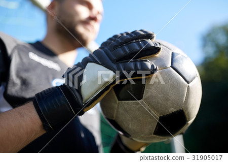 close up of goalkeeper with ball playing football 31905017