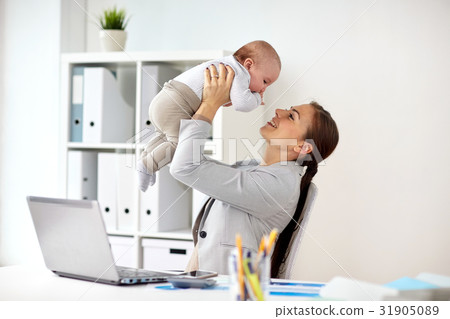 happy businesswoman with baby and laptop at office happy businesswoman with baby and laptop at office 31905089