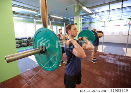 group of men training with barbells in gym group of men training with barbells in gym 31905539