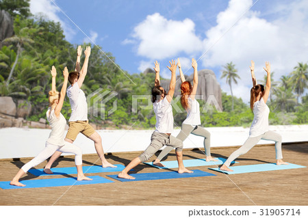 group of people making yoga exercises on beach group of people making yoga exercises on beach 31905714