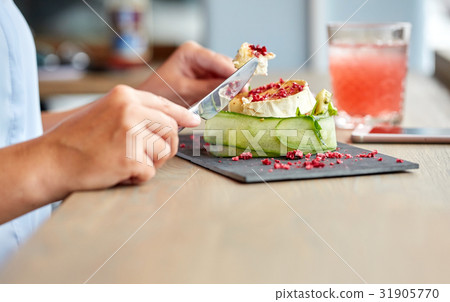 woman eating goat cheese salad at restaurant 31905770