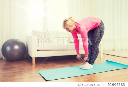 smiling woman with dumbbells exercising at home smiling woman with dumbbells exercising at home 31906383