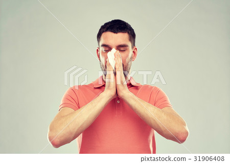 sick man with paper napkin blowing nose sick man with paper napkin blowing nose 31906408