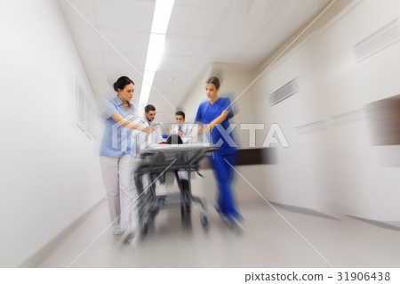 medics and patient on hospital gurney at emergency 31906438