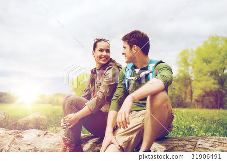smiling couple with backpacks in nature 31906491