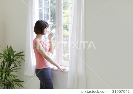 Japanese women drinking water at the window Japanese women drinking water at the window 31907041