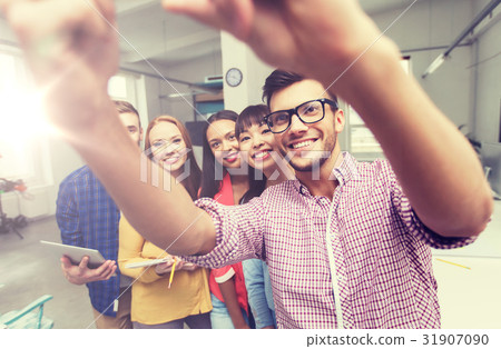 creative business team taking selfie at office 31907090