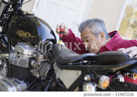 Men who maintain the motorcycle 31907226