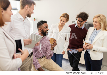 happy business team drinking coffee at office happy business team drinking coffee at office 31907395