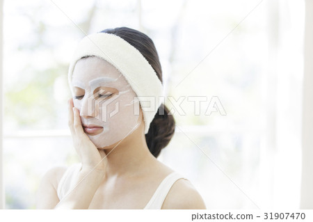 A woman with a mask on his face A woman with a mask on his face 31907470