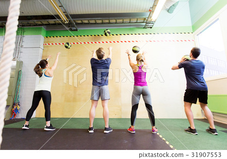 group of people with medicine ball training in gym 31907553