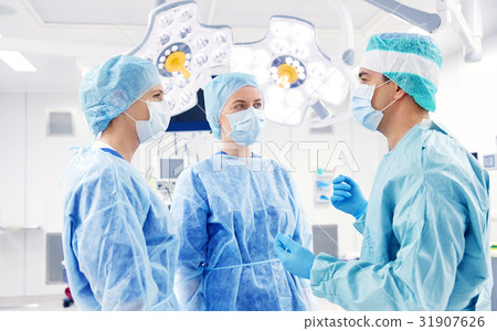 group of surgeons in operating room at hospital group of surgeons in operating room at hospital 31907626