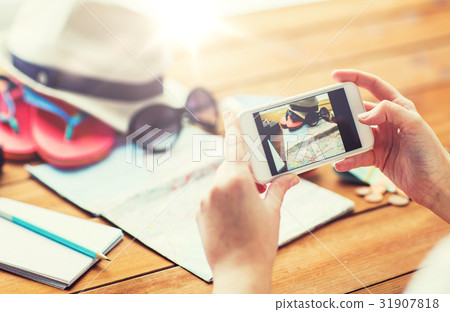 close up of woman with smartphone and travel stuff 31907818