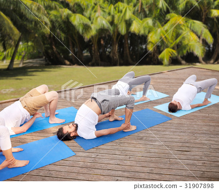 group of people making yoga exercises outdoors group of people making yoga exercises outdoors 31907898