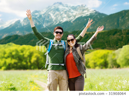 happy couple with backpacks hiking outdoors 31908064