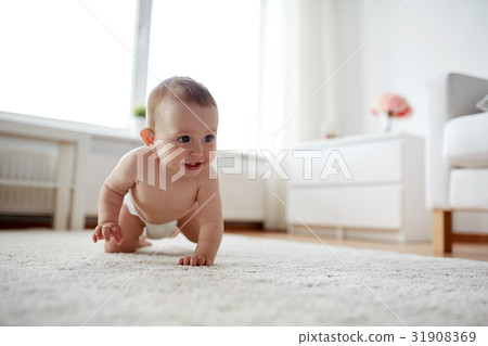 little baby in diaper crawling on floor at home 31908369