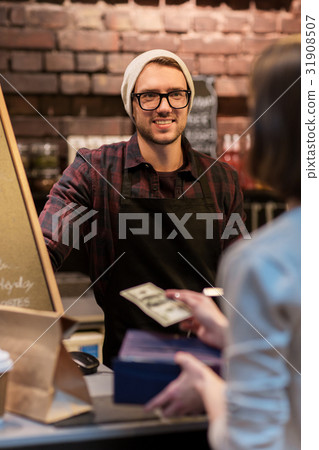 happy barman and woman paying money at cafe 31908507