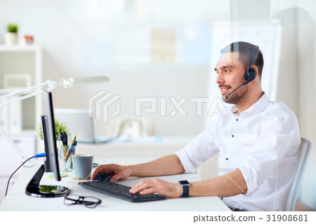 businessman with headset and computer at office businessman with headset and computer at office 31908681