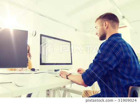 creative man or programmer with computer at office 31909024