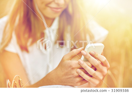 close up of woman with smartphone and earphones 31909386