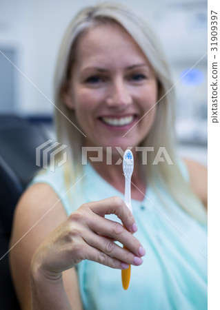 Woman holding tooth brush 31909397