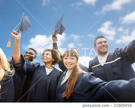 happy bachelors waving mortar boards over sky 31909458