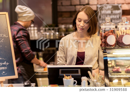 woman bartender at cafe or coffee shop cashbox woman bartender at cafe or coffee shop cashbox 31909588