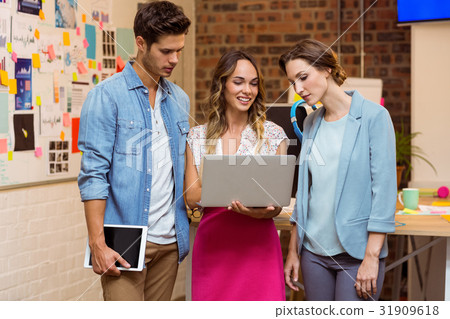 Business people discussing over laptop 31909618