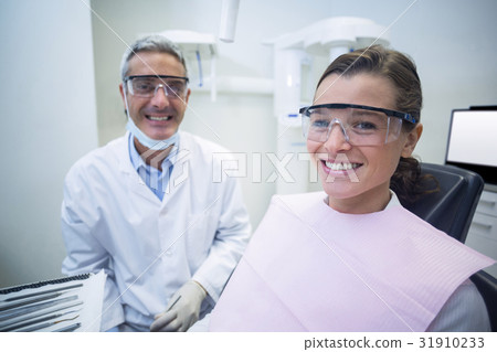 Dentist smiling with female patient 31910233