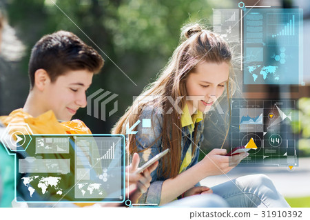 happy teenage friends with gadgets outdoors happy teenage friends with gadgets outdoors 31910392